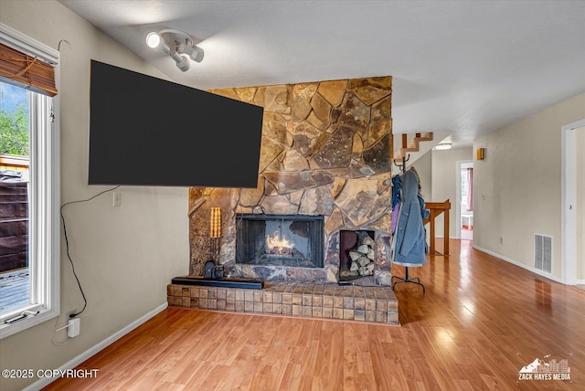 6010 Staedem Dr, Anchorage, AK 99504 - living area featuring wood finished floors, baseboards, and a stone fireplace