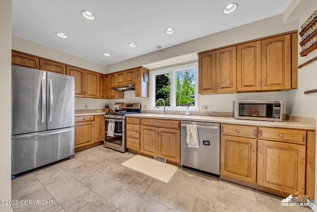 6010 Staedem Dr, Anchorage, AK 99504 - kitchen with appliances with stainless steel finishes, under cabinet range hood, a sink, light countertops, and recessed lighting