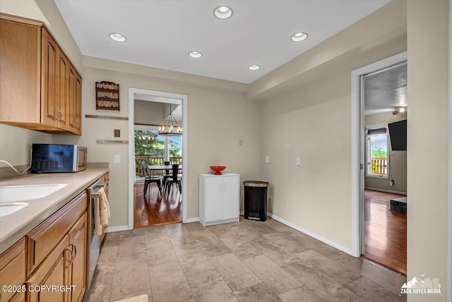 6010 Staedem Dr, Anchorage, AK 99504 - kitchen featuring plenty of natural light, stainless steel microwave, light countertops, a chandelier, and recessed lighting
