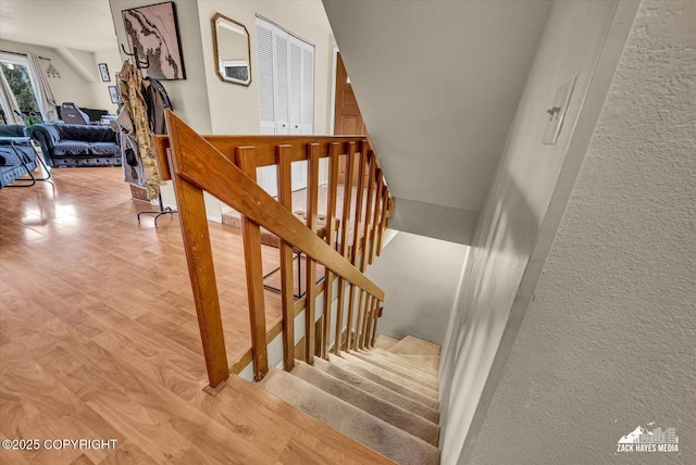 6010 Staedem Dr, Anchorage, AK 99504 - stairway featuring wood finished floors and a textured wall