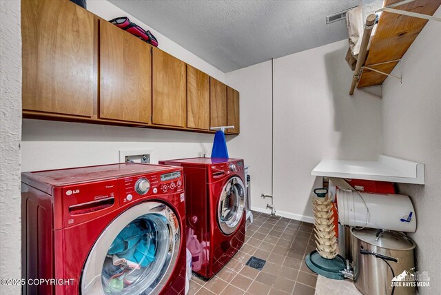 6010 Staedem Dr, Anchorage, AK 99504 - washroom featuring cabinet space, dark tile patterned floors, washer and dryer, a textured ceiling, and baseboards