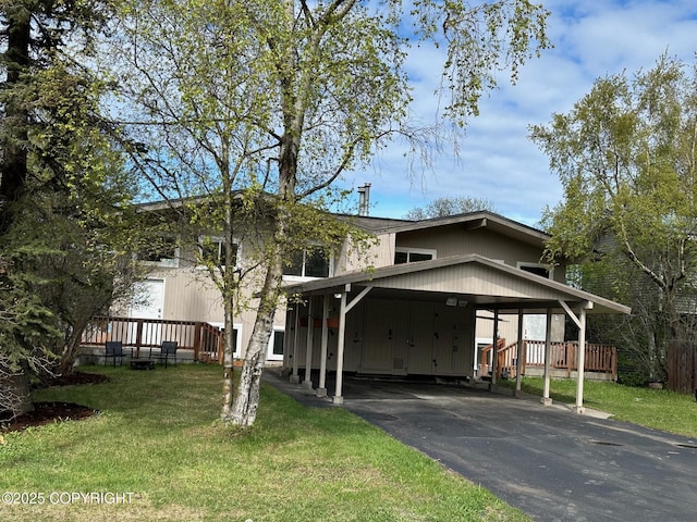 741 W 20th Ave, Anchorage, AK 99503 - view of front of home with asphalt driveway, an attached carport, a front yard, and a wooden deck
