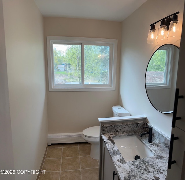 741 W 20th Ave, Anchorage, AK 99503 - bathroom with a baseboard heating unit, plenty of natural light, toilet, and baseboards