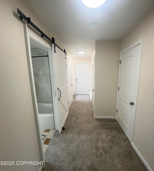741 W 20th Ave, Anchorage, AK 99503 - hallway featuring a barn door, carpet floors, and baseboards