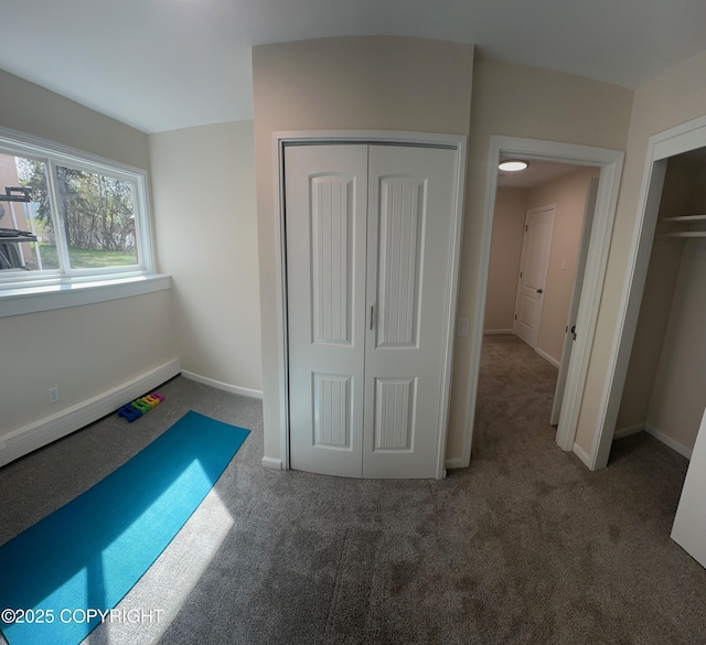 741 W 20th Ave, Anchorage, AK 99503 - unfurnished bedroom featuring carpet flooring, baseboard heating, baseboards, and a closet