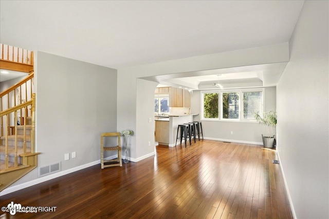 3833 Eastwind Dr, Anchorage, AK 99516 - living room featuring stairway, baseboards, hardwood / wood-style floors, and a tray ceiling