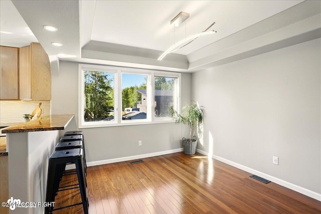 3833 Eastwind Dr, Anchorage, AK 99516 - dining area featuring a raised ceiling, hardwood / wood-style floors, baseboards, and recessed lighting