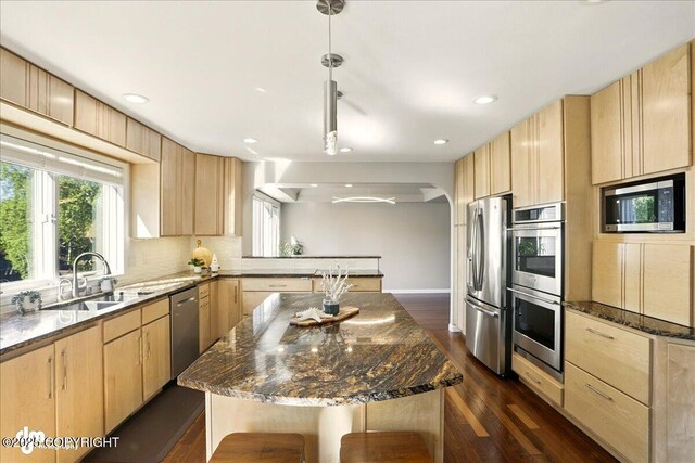 3833 Eastwind Dr, Anchorage, AK 99516 - kitchen with light brown cabinetry, stainless steel appliances, a sink, a peninsula, and recessed lighting