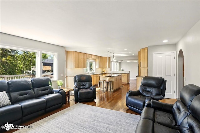 3833 Eastwind Dr, Anchorage, AK 99516 - living area with arched walkways, wood finished floors, and recessed lighting