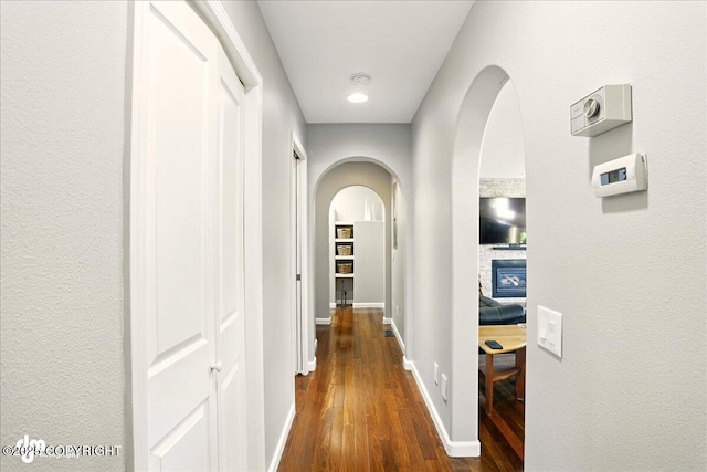 3833 Eastwind Dr, Anchorage, AK 99516 - corridor with dark wood-style floors, arched walkways, and baseboards