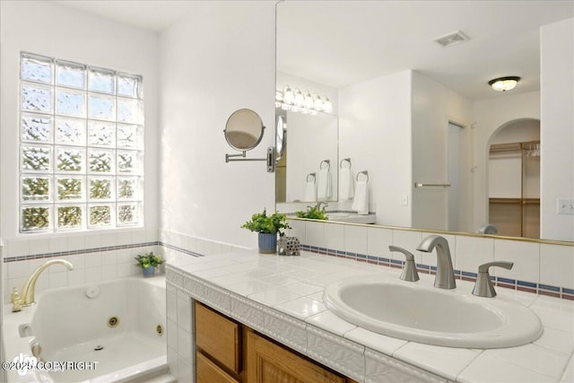3833 Eastwind Dr, Anchorage, AK 99516 - full bath featuring healthy amount of natural light, a tub with jets, and vanity