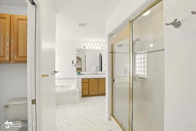 3833 Eastwind Dr, Anchorage, AK 99516 - full bathroom with a garden tub, marble look tiles, vanity, and a shower stall