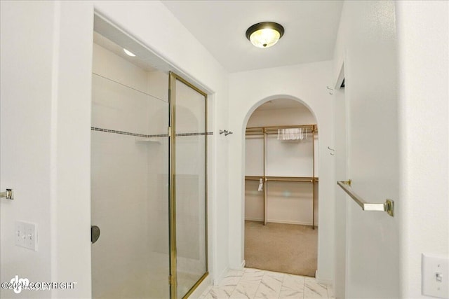 3833 Eastwind Dr, Anchorage, AK 99516 - bathroom with a stall shower, a walk in closet, and marble look tile flooring