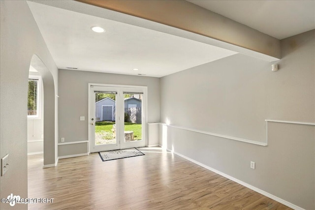 3833 Eastwind Dr, Anchorage, AK 99516 - empty room with wood finished floors, arched walkways, recessed lighting, and baseboards