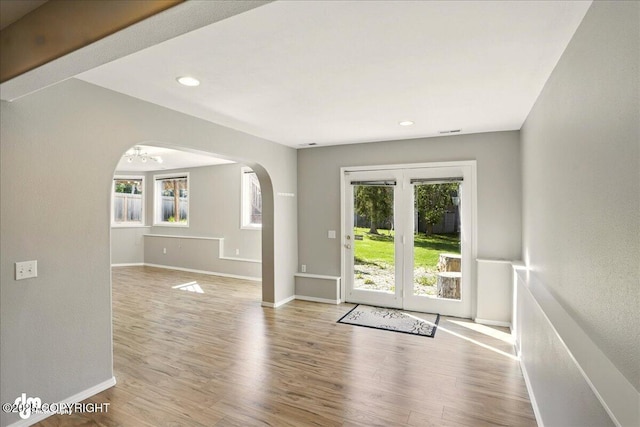 3833 Eastwind Dr, Anchorage, AK 99516 - empty room with arched walkways, wood finished floors, baseboards, and recessed lighting