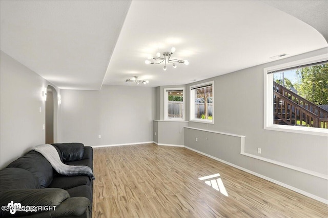 3833 Eastwind Dr, Anchorage, AK 99516 - living area featuring arched walkways, light wood-style flooring, and baseboards
