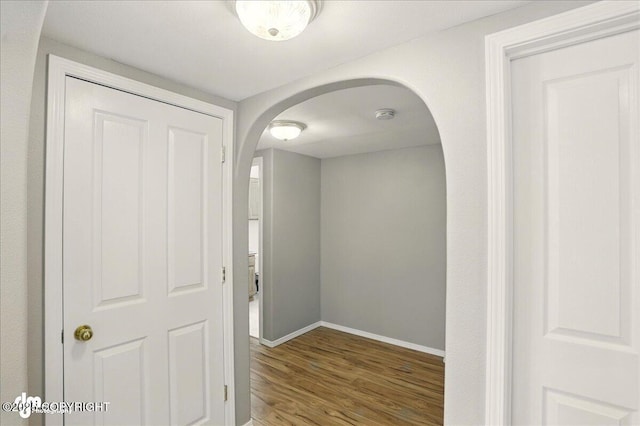 3833 Eastwind Dr, Anchorage, AK 99516 - hall with arched walkways, baseboards, and wood finished floors