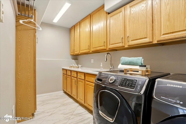3833 Eastwind Dr, Anchorage, AK 99516 - washroom featuring washer and clothes dryer, light marble finish floors, and cabinet space