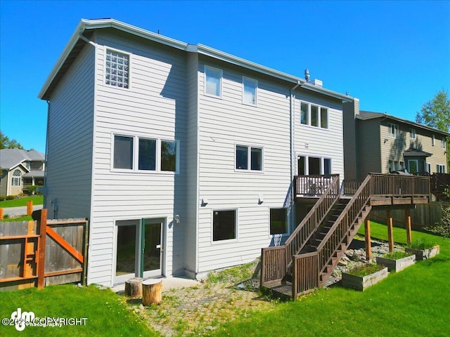 3833 Eastwind Dr, Anchorage, AK 99516 - rear view of property featuring a wooden deck, stairway, and a vegetable garden