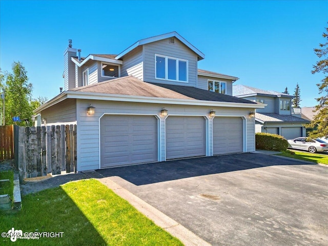 3833 Eastwind Dr, Anchorage, AK 99516 - view of front facade featuring a chimney, asphalt driveway, a garage, and a shingled roof