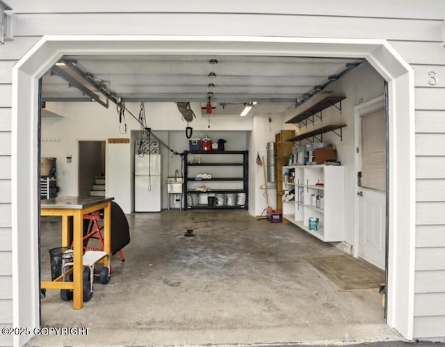 3833 Eastwind Dr, Anchorage, AK 99516 - garage featuring freestanding refrigerator