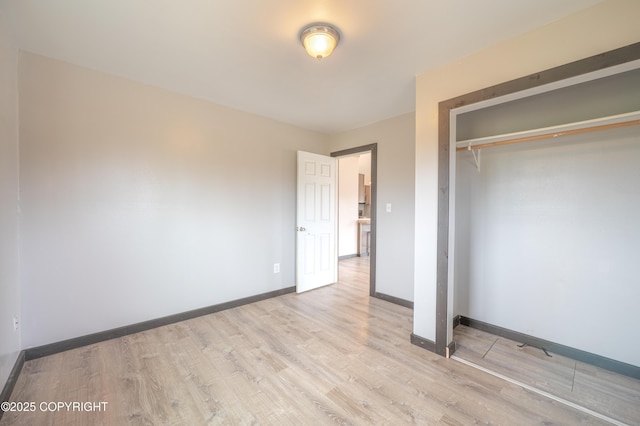 33533 Alder St, Anchor Point, AK 99556 - unfurnished bedroom with wood finished floors, a closet, and baseboards