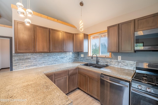 33533 Alder St, Anchor Point, AK 99556 - kitchen with appliances with stainless steel finishes, lofted ceiling, a sink, backsplash, and decorative light fixtures
