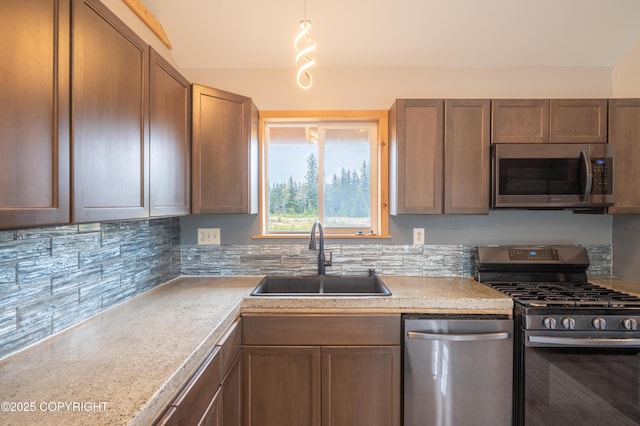 33533 Alder St, Anchor Point, AK 99556 - kitchen featuring stainless steel appliances, a sink, backsplash, and light countertops