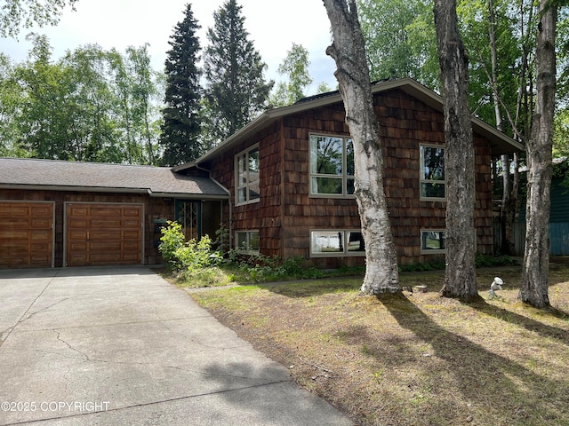 2060 Saratoga Ave, Anchorage, AK 99517 - tri-level home featuring concrete driveway and a garage