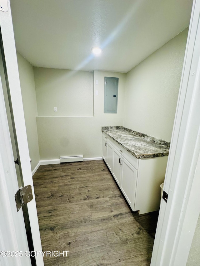 5670 W Calico Dr, Wasilla, AK 99654 - laundry area with a baseboard radiator, electric panel, wood finished floors, and baseboards