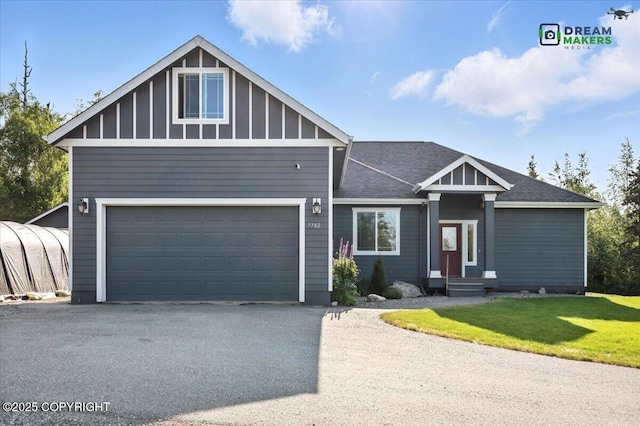 7782 W Arlie Rd, Wasilla, AK 99623 - view of front of home featuring a front yard, driveway, board and batten siding, and an attached garage