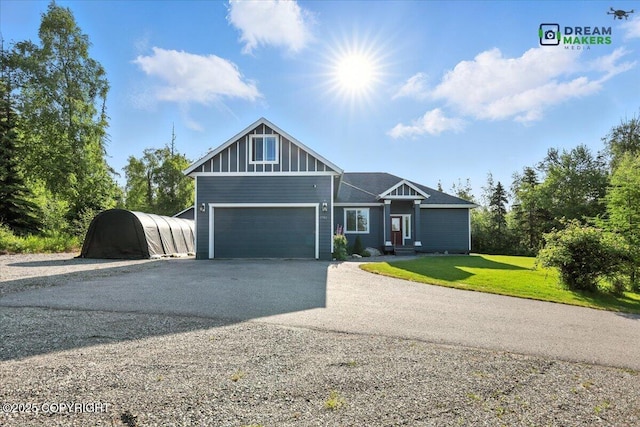 7782 W Arlie Rd, Wasilla, AK 99623 - craftsman-style house featuring driveway, an attached garage, and a front lawn