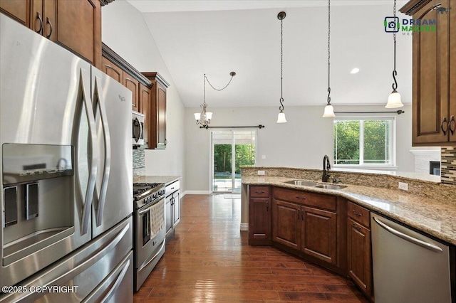 7782 W Arlie Rd, Wasilla, AK 99623 - kitchen with appliances with stainless steel finishes, plenty of natural light, dark wood-style floors, decorative backsplash, and vaulted ceiling