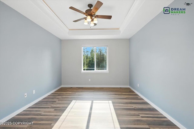 7782 W Arlie Rd, Wasilla, AK 99623 - spare room featuring a raised ceiling, ceiling fan, wood finished floors, and ornamental molding