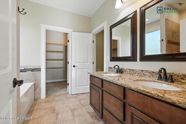 7782 W Arlie Rd, Wasilla, AK 99623 - bathroom featuring a garden tub, double vanity, and a spacious closet