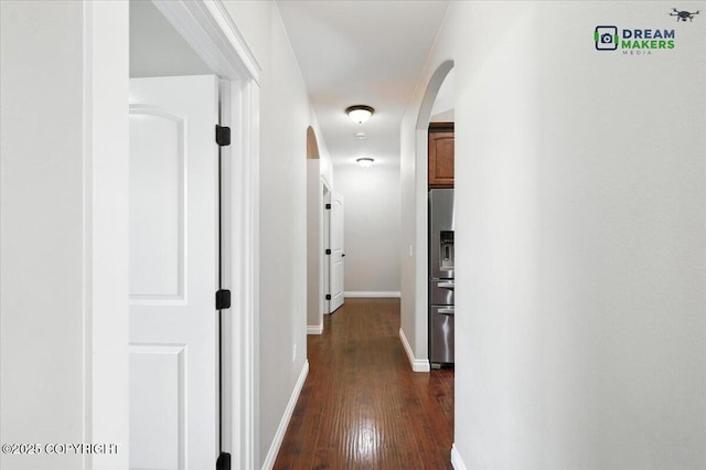 7782 W Arlie Rd, Wasilla, AK 99623 - hall with arched walkways and dark wood-style floors