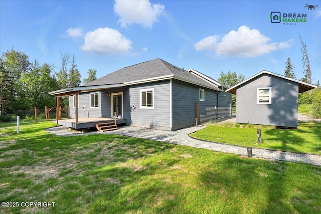7782 W Arlie Rd, Wasilla, AK 99623 - rear view of house featuring a deck and a lawn