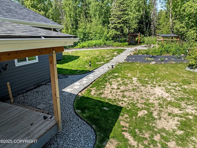 7782 W Arlie Rd, Wasilla, AK 99623 - view of green lawn featuring a view of trees