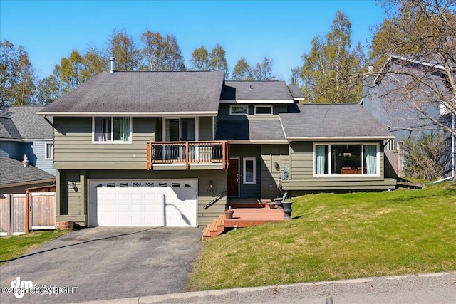 split level home with a balcony, driveway, and an attached garage