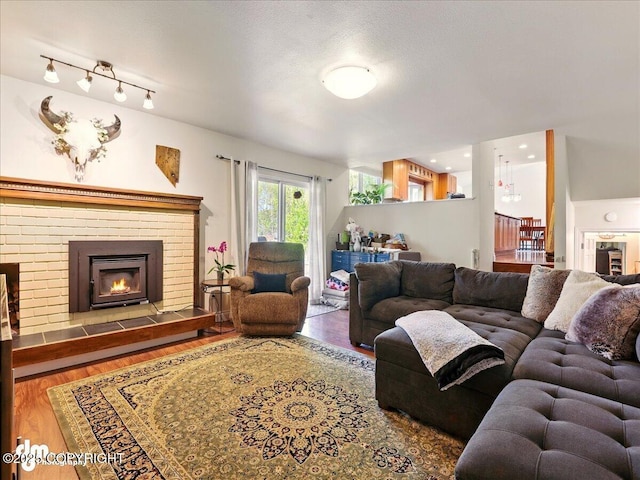 living room with wood finished floors and a fireplace