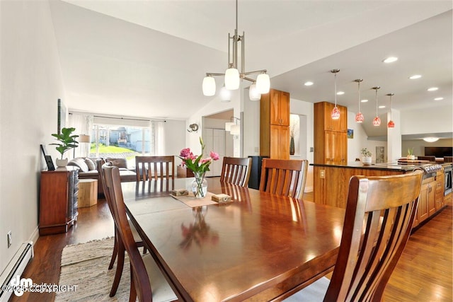 dining space featuring a baseboard radiator, wood finished floors, recessed lighting, lofted ceiling, and baseboards