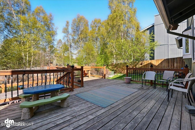 wooden terrace featuring fence