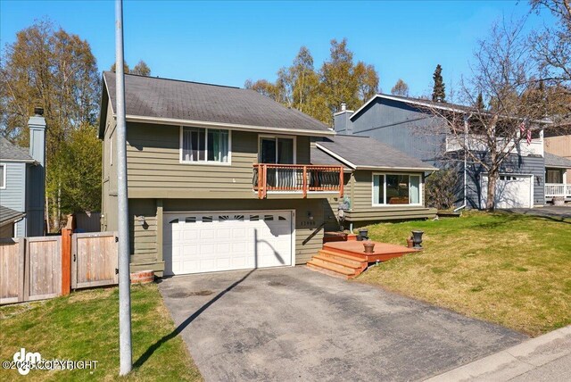 view of front of house with driveway, a garage, and a balcony