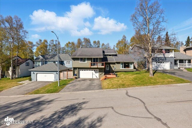 tri-level home featuring asphalt driveway and a residential view
