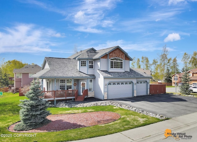 traditional-style house with a porch, an attached garage, driveway, a front lawn, and a shingled roof