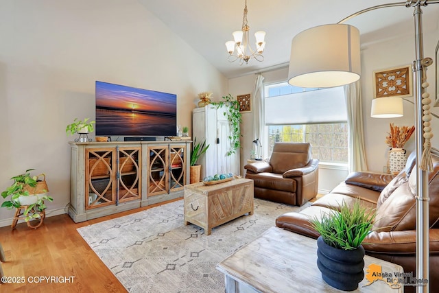 living room with wood finished floors, a chandelier, lofted ceiling, and baseboards