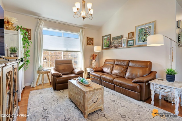 living area featuring a chandelier, wood finished floors, vaulted ceiling, and baseboards