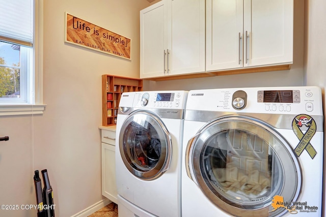 laundry area featuring washer and clothes dryer, cabinet space, and baseboards