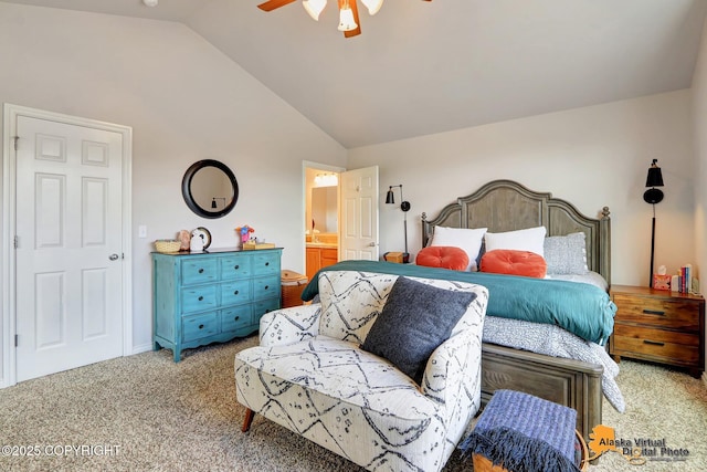carpeted bedroom featuring lofted ceiling, ceiling fan, and ensuite bath