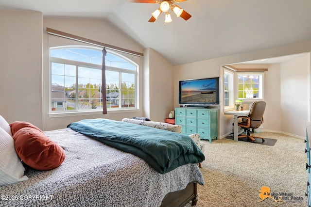 carpeted bedroom featuring vaulted ceiling, ceiling fan, and baseboards